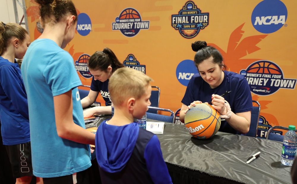 Iowa Hawkeyes forward Megan Gustafson (10) signs autographs with the other WBCA All Americans at the Tourney Town Fan Fest Friday, April 5, 2019 at the Tampa Convention Center in Tampa, FL. (Brian Ray/hawkeyesports.com)