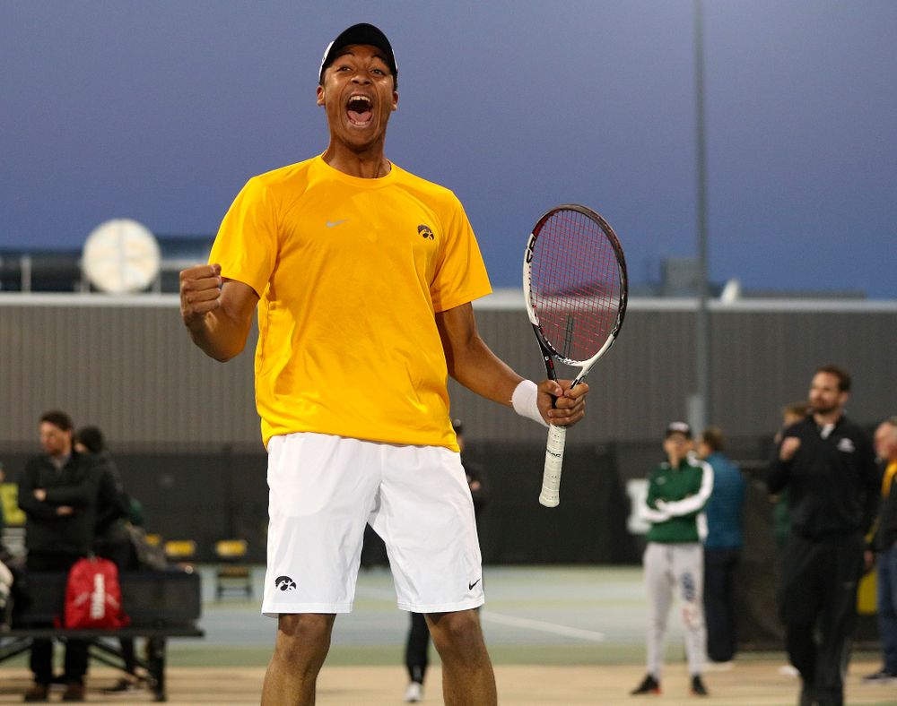 Iowa's Oliver Okonkwo celebrates after winning his match again Michigan State at the Hawkeye Tennis and Recreation Complex in Iowa City on Friday, Apr. 19, 2019. (Stephen Mally/hawkeyesports.com)