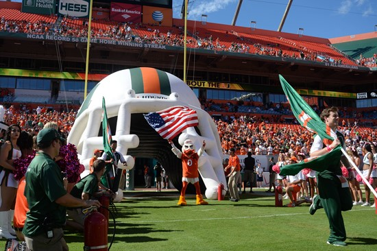 Sebastian the Ibis leads the University of Miami Hurricanes through a tunnel of smoke in a game against the Georgia Tech Yellow Jackets at Sun Life...