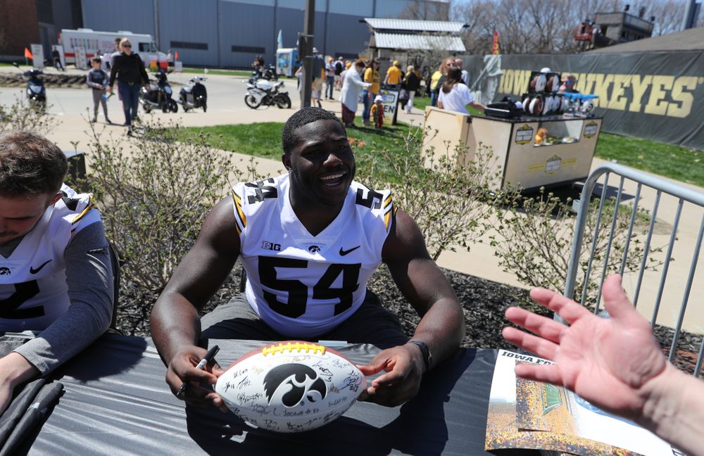 Members of the Iowa Football team sign autographs before the Iowa Hawkeyes game against the Nebraska Cornhuskers Saturday, April 20, 2019 at Duane Banks Field. (Brian Ray/hawkeyesports.com)