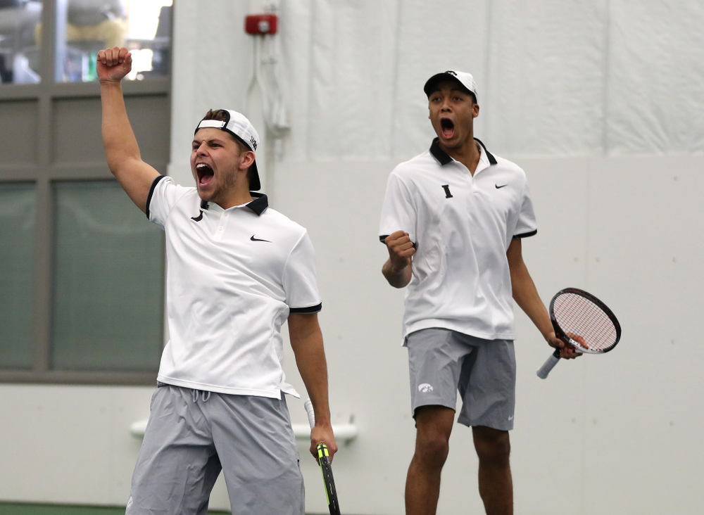 Iowa's Will Davies and Oliver Okonkwo celebrate after winning a doubles match against Western Michigan Saturday, January 19, 2019 at the Hawkeye Tennis and Recreation Complex. (Brian Ray/hawkeyesports.com)