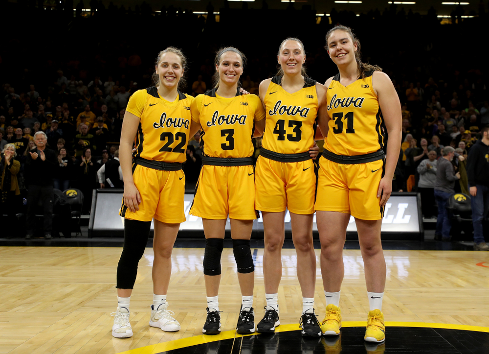 Iowa Hawkeyes guard Kathleen Doyle (22), guard Makenzie Meyer (3), forward Amanda Ollinger (43), and forward/center Paula Valiño Ramos (31) during senior day activities following their win over the Minnesota Golden Gophers Thursday, February 27, 2020 at Carver-Hawkeye Arena. (Brian Ray/hawkeyesports.com)