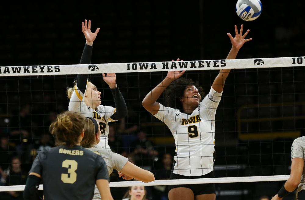 Iowa Hawkeyes right side hitter Reghan Coyle (8) and Iowa Hawkeyes middle blocker Amiya Jones (9) go up for a block during a game against Purdue at Carver-Hawkeye Arena on October 13, 2018. (Tork Mason/hawkeyesports.com)
