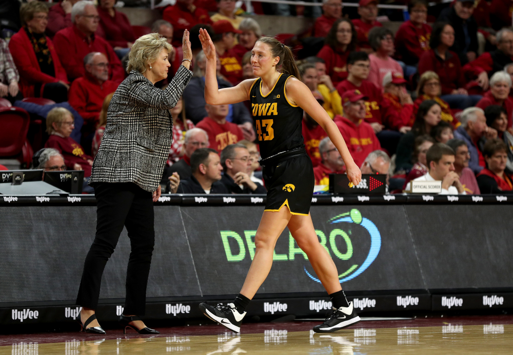 Iowa Hawkeyes forward Amanda Ollinger (43) high fives head coach Lisa Bluder against the Iowa State Cyclones Wednesday, December 11, 2019 at Hilton Coliseum in Ames, Iowa(Brian Ray/hawkeyesports.com)