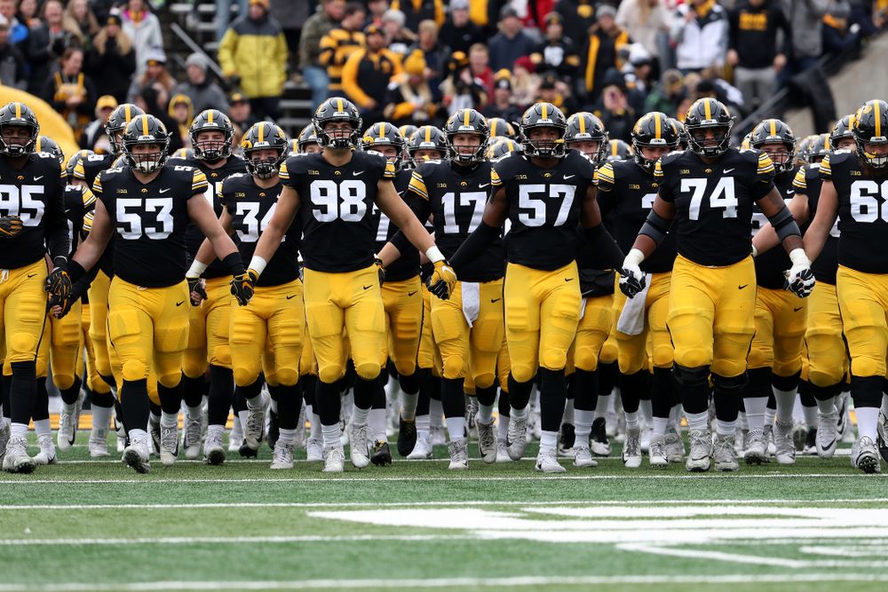 The Iowa Hawkeyes swarm onto the field before their game against the Nebraska Cornhuskers Friday, November 23, 2018 at Kinnick Stadium. (Brian Ray/hawkeyesports.com)