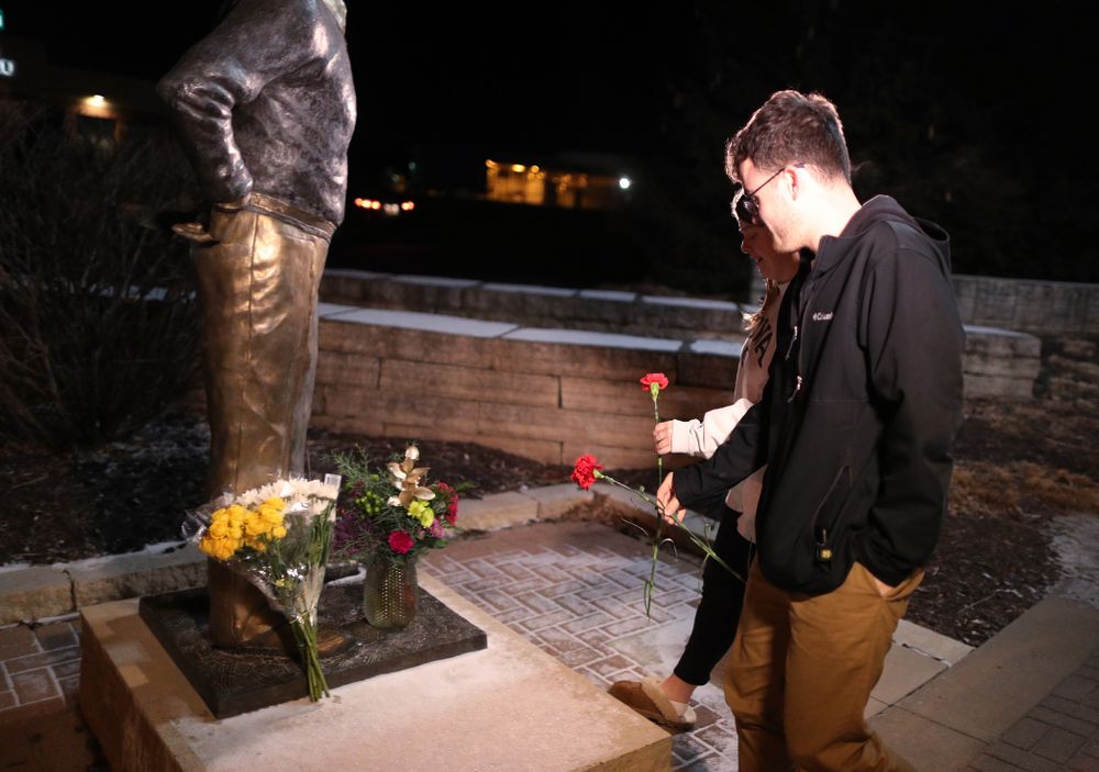 Mourners lay flowers at the statue of former Hawkeye Football Head Coach Hayden Fry Tuesday, December 17, 2019 in Coralville. Fry passed away on Tuesday at the age of 90. (Brian Ray/hawkeyesports.com)