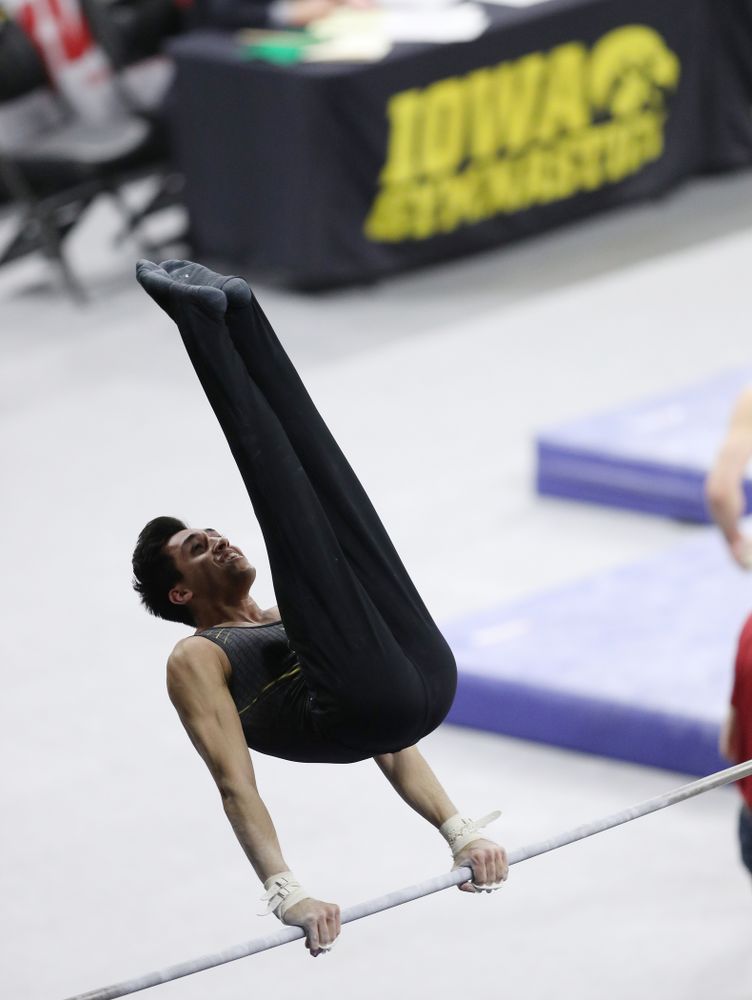 Iowa's Andrew Herrador competes on the high bar against Oklahoma Saturday, February 9, 2019 at Carver-Hawkeye Arena. (Brian Ray/hawkeyesports.com)