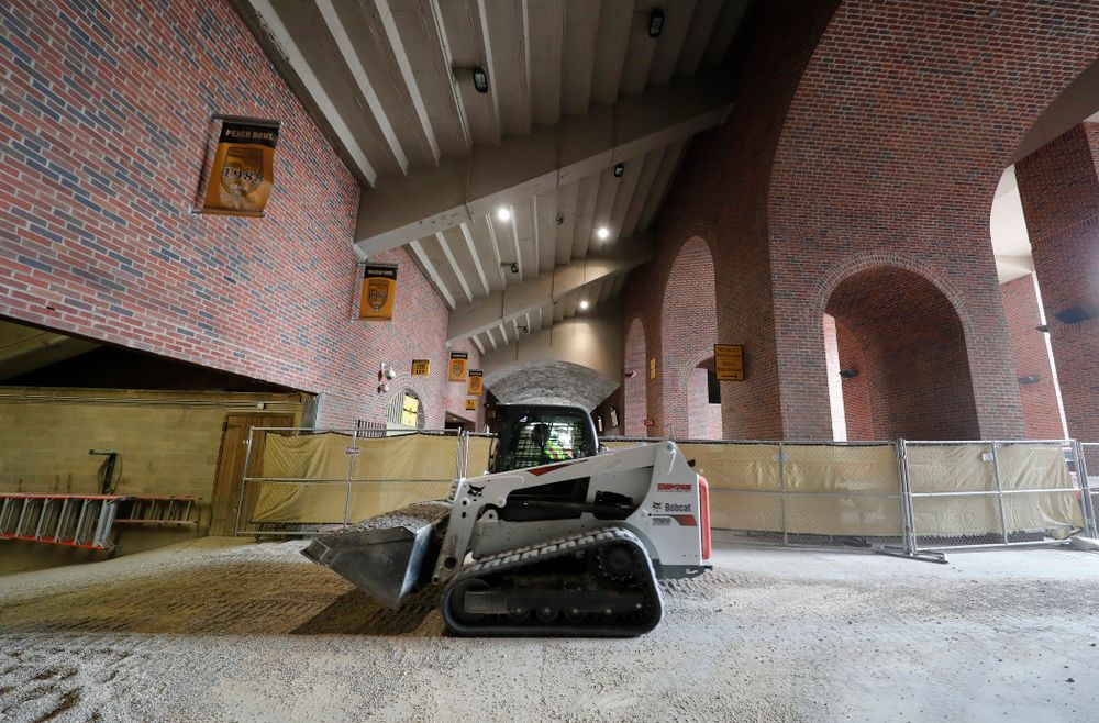 Workers haul gravel down the the field Wednesday, June 6, 2018 at Kinnick Stadium. (Brian Ray/hawkeyesports.com)