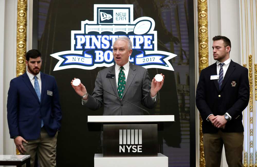 Iowa Hawkeyes linebacker Josey Jewell (43), defensive back Joshua Jackson (15), offensive lineman Sean Welsh (79) and head coach Kirk Ferentz ring the opening bell at the New York Stock Exchange Tuesday, December 26, 2017 in New York. (Brian Ray/hawkeyesports.com)