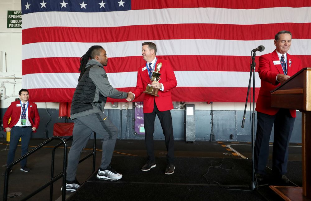 Iowa Hawkeyes defensive back Devonte Young (17) revives the U.S. Grant Sharp AdmiralÕs Trophy during tour of the USS Theodore Roosevelt (CVN-71) Tuesday, December 24, 2019 at the Naval Base Coronado. (Brian Ray/hawkeyesports.com)