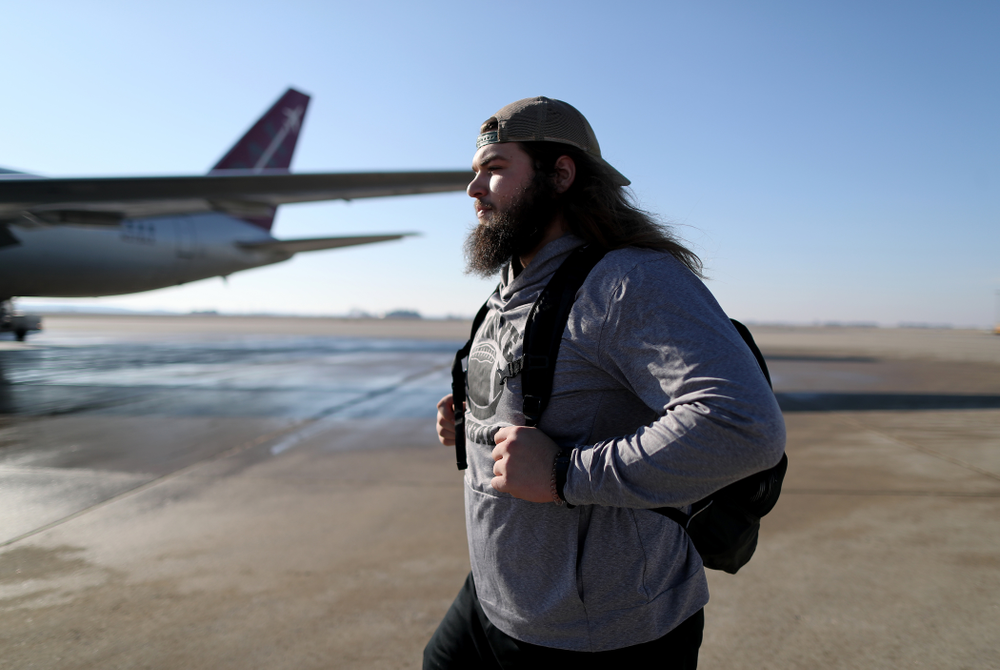 Iowa Hawkeyes offensive lineman Kyler Schott (64) boards the team plane at the Eastern Iowa Airport Saturday, December 21, 2019 on the way to San Diego, CA for the Holiday Bowl. (Brian Ray/hawkeyesports.com)