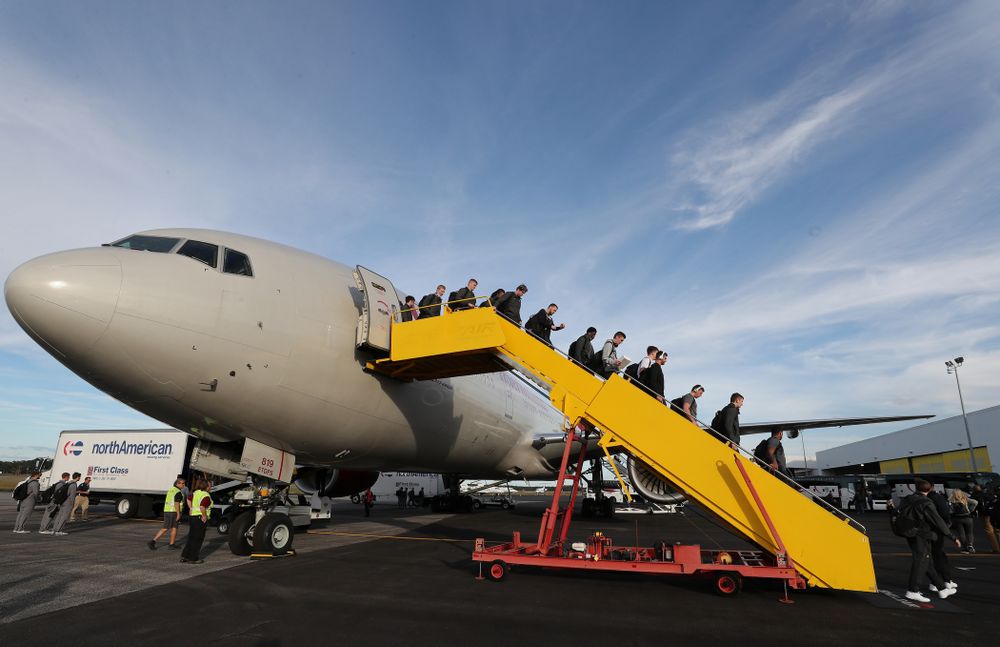 The Iowa Hawkeyes disembark the team plane Wednesday, December 26, 2018 as they arrive in Tampa, Florida for the Outback Bowl. (Brian Ray/hawkeyesports.com)