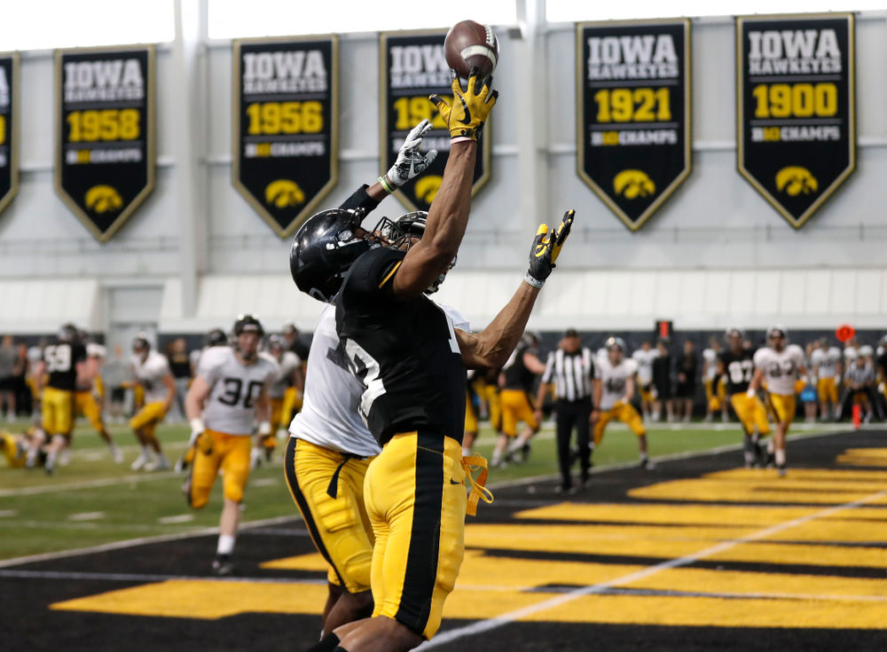Iowa Hawkeyes wide receiver Brandon Smith (12) and defensive back Michael Ojemudia (11) during spring practice Saturday, March 31, 2018 at the Hansen Football Performance Center. (Brian Ray/hawkeyesports.com)