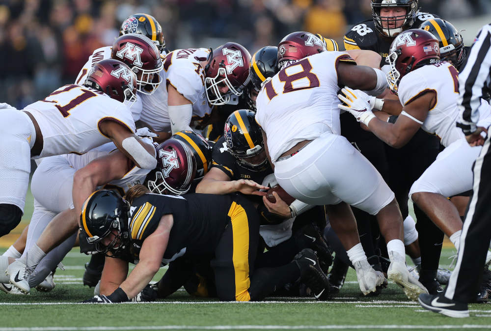 Iowa Hawkeyes quarterback Nate Stanley (4) picks up a first down against the Minnesota Golden Gophers Saturday, November 16, 2019 at Kinnick Stadium. (Brian Ray/hawkeyesports.com)