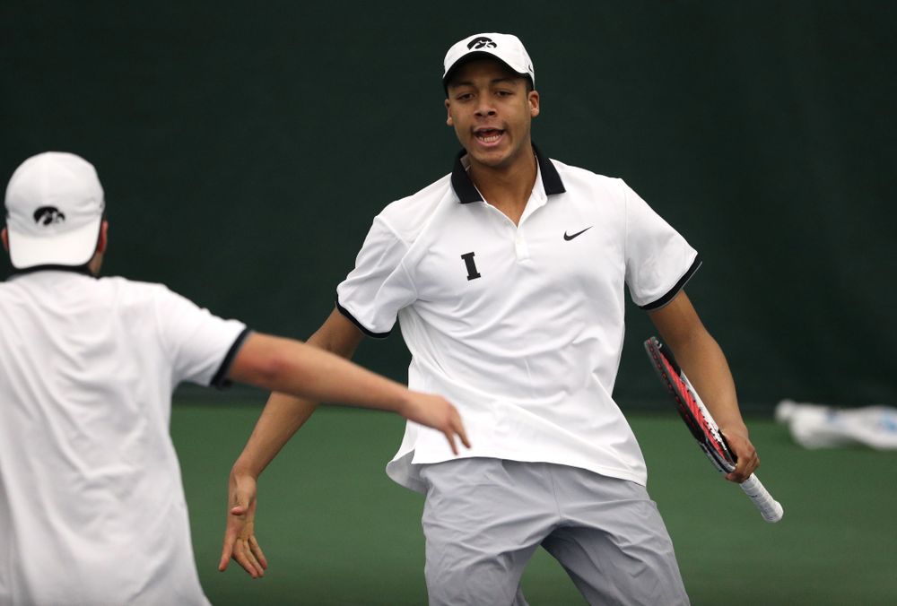 Iowa's Will Davies and Oliver Okonkwo celebrate after winning a doubles match against Western Michigan Saturday, January 19, 2019 at the Hawkeye Tennis and Recreation Complex. (Brian Ray/hawkeyesports.com)