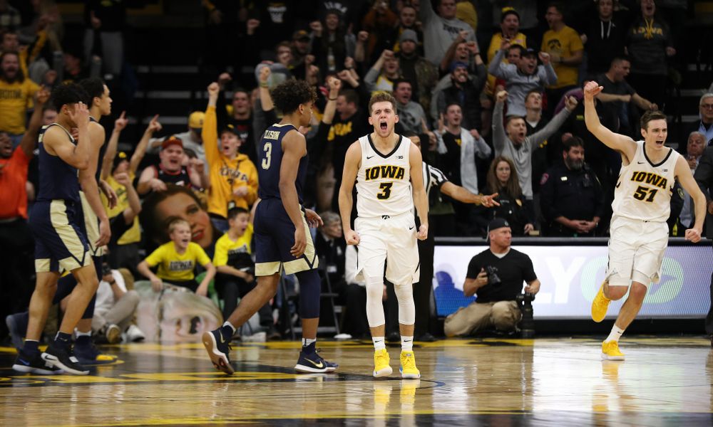 Iowa Hawkeyes guard Jordan Bohannon (3) and forward Nicholas Baer (51) celebrate their victory against the Pitt Panthers Tuesday, November 27, 2018 at Carver-Hawkeye Arena. (Brian Ray/hawkeyesports.com)
