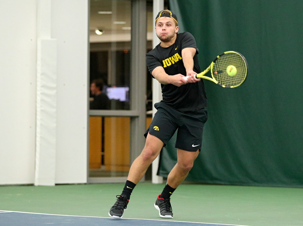 Iowa’s Will Davies returns a shot during their match at the Hawkeye Tennis and Recreation Complex in Iowa City on Thursday, January 16, 2020. (Stephen Mally/hawkeyesports.com)