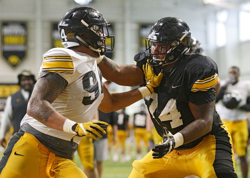 Iowa Hawkeyes defensive end A.J. Epenesa (94) and offensive lineman Tristan Wirfs (74) work on a drill during Fall Camp Practice No. 6 at the Hansen Football Performance Center in Iowa City on Thursday, Aug 8, 2019. (Stephen Mally/hawkeyesports.com)
