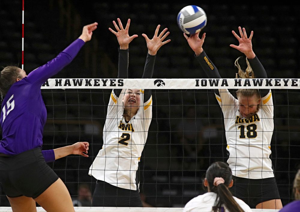 Iowa’s Hannah Clayton (18) gets her hands on a shot as Courtney Buzzerio (2) also jumps during their Big Ten/Pac-12 Challenge match at Carver-Hawkeye Arena in Iowa City on Saturday, Sep 7, 2019. (Stephen Mally/hawkeyesports.com)