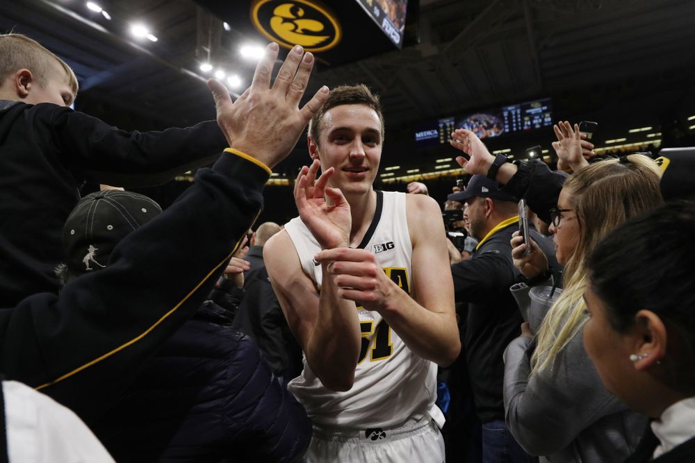 Iowa Hawkeyes forward Nicholas Baer (51) celebrates with fans after defeating the Michigan Wolverines Friday, February 1, 2019 at Carver-Hawkeye Arena. (Brian Ray/hawkeyesports.com)