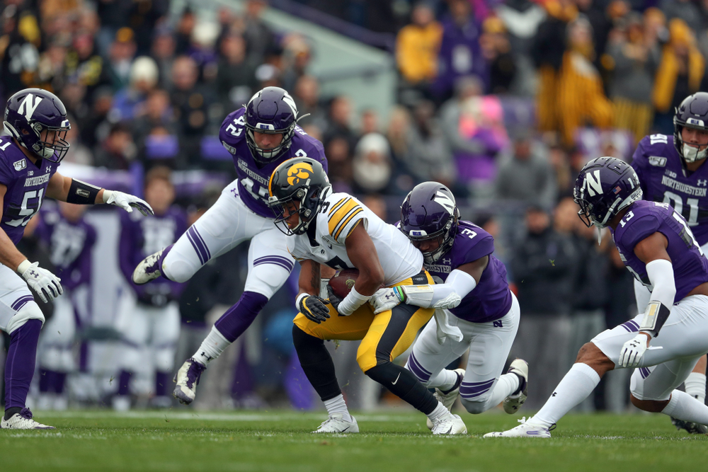 Iowa Hawkeyes wide receiver Tyrone Tracy Jr. (3) spins away from 5 defenders on his way to a touchdown against the Northwestern Wildcats Saturday, October 26, 2019 at Ryan Field in Evanston, Ill. (Brian Ray/hawkeyesports.com)