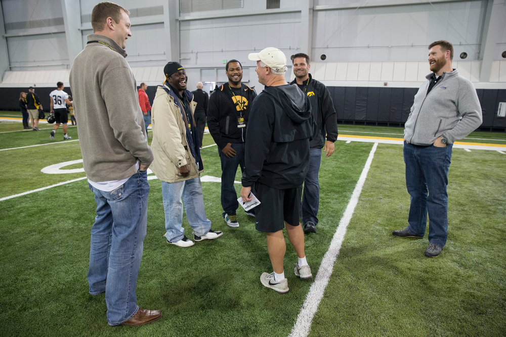 Iowa Hawkeyes defensive line coach Reese Morgan talks with members of the 2004 Big Ten Championship team following the team's walk through Friday, Sept. 12, 2014 in Iowa City. (Brian Ray/hawkeyesports.com)