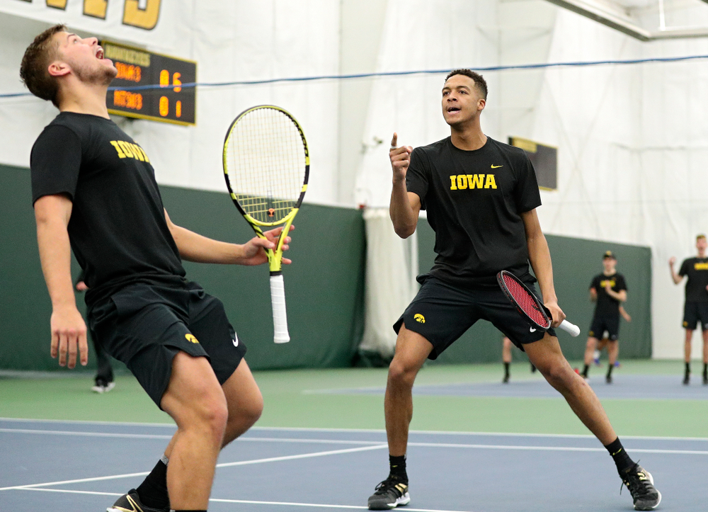 Iowa’s Will Davies (from left) and Oliver Okonkwo celebrate a point during their doubles match at the Hawkeye Tennis and Recreation Complex in Iowa City on Friday, February 14, 2020. (Stephen Mally/hawkeyesports.com)
