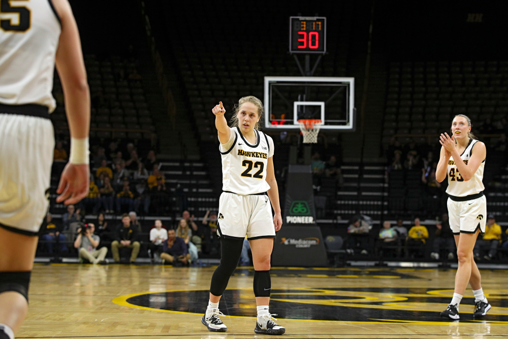Iowa Hawkeyes guard Kathleen Doyle (22) points to forward Monika Czinano (25) after she made a basket while being fouled as forward Amanda Ollinger (43) claps during the second quarter of the game at Carver-Hawkeye Arena in Iowa City on Thursday, February 6, 2020. (Stephen Mally/hawkeyesports.com)