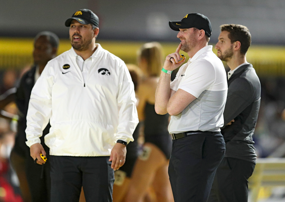 Iowa director of track and field Joey Woody (right) laughs as he talks with assistant coach/recruiting coordinator Jason Wakenight between the men’s and women’s 1600 meter relay event during the Hawkeye Invitational at the Recreation Building in Iowa City on Saturday, January 11, 2020. (Stephen Mally/hawkeyesports.com)