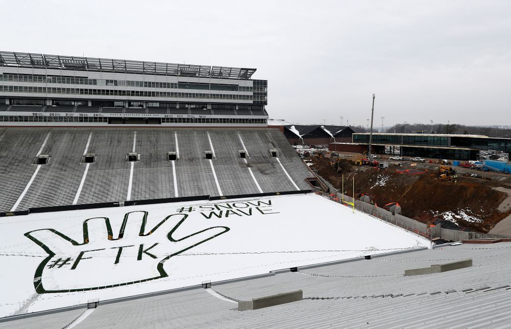 Members of the Iowa Athletics Turf Management staff create the #SnowWave for kids in the Stead Family Children's Hospital Thursday, February