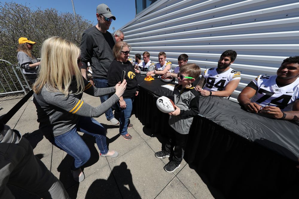 Members of the Iowa Football team sign autographs before the Iowa Hawkeyes game against the Nebraska Cornhuskers Saturday, April 20, 2019 at Duane Banks Field. (Brian Ray/hawkeyesports.com)