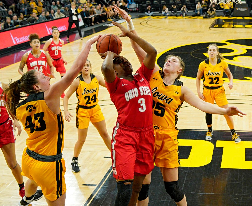 Iowa Hawkeyes forward Amanda Ollinger (43) blocks a shot by Ohio State Buckeyes guard Janai Crooms (3) as forward Monika Czinano (25) defends during the third quarter of their game at Carver-Hawkeye Arena in Iowa City on Thursday, January 23, 2020. (Stephen Mally/hawkeyesports.com)
