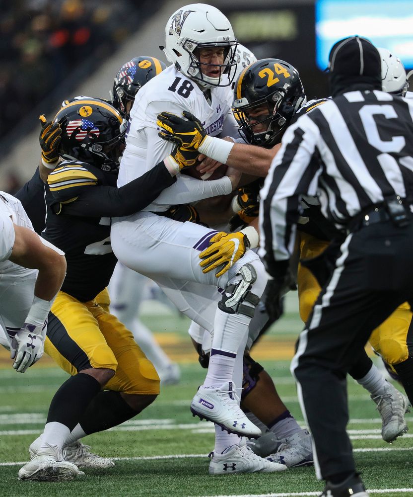 Iowa Hawkeyes defensive back Amani Hooker (27) and Iowa Hawkeyes linebacker Jack Hockaday (48) sack the quarterback during a game against Northwestern at Kinnick Stadium on November 10, 2018. (Tork Mason/hawkeyesports.com)
