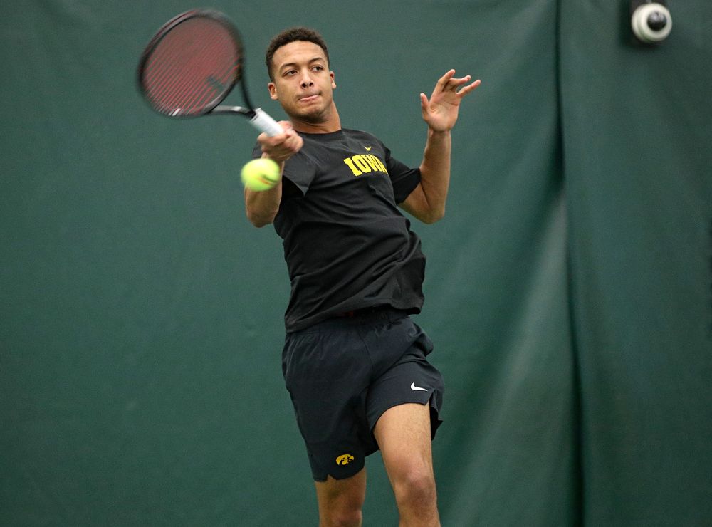 Iowa’s Oliver Okonkwo hits a shot during his match against Marquette at the Hawkeye Tennis and Recreation Complex in Iowa City on Saturday, January 25, 2020. (Stephen Mally/hawkeyesports.com)