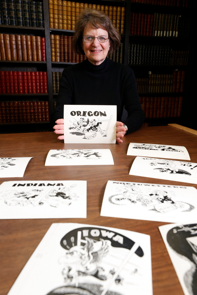 Jane Roth sits with some of the original drawings of Herky the Hawk Friday, April 20, 2018 at the University of Iowa Library. Roth has donated the drawings, which were created by artist Dick Spencer, to the library's special collection. (Brian Ray/hawkeyesports.com)