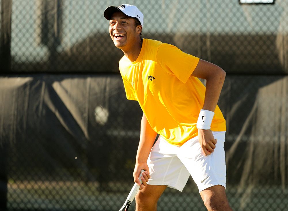 Iowa's Oliver Okonkwo smiles during their doubles match again Michigan State at the Hawkeye Tennis and Recreation Complex in Iowa City on Friday, Apr. 19, 2019. (Stephen Mally/hawkeyesports.com)