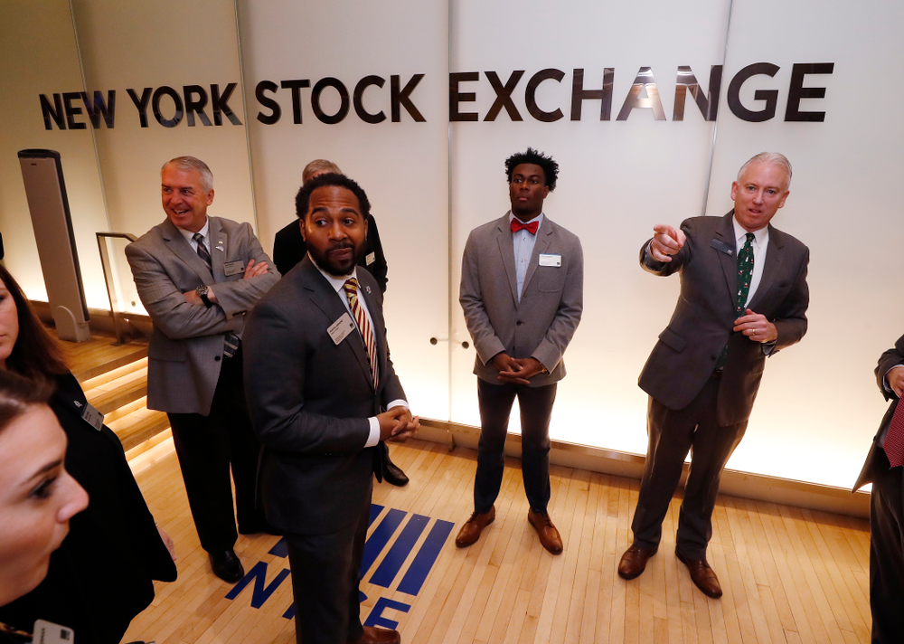 Iowa Hawkeyes linebacker Josey Jewell (43), defensive back Joshua Jackson (15), offensive lineman Sean Welsh (79) and head coach Kirk Ferentz ring the opening bell at the New York Stock Exchange Tuesday, December 26, 2017 in New York. (Brian Ray/hawkeyesports.com)