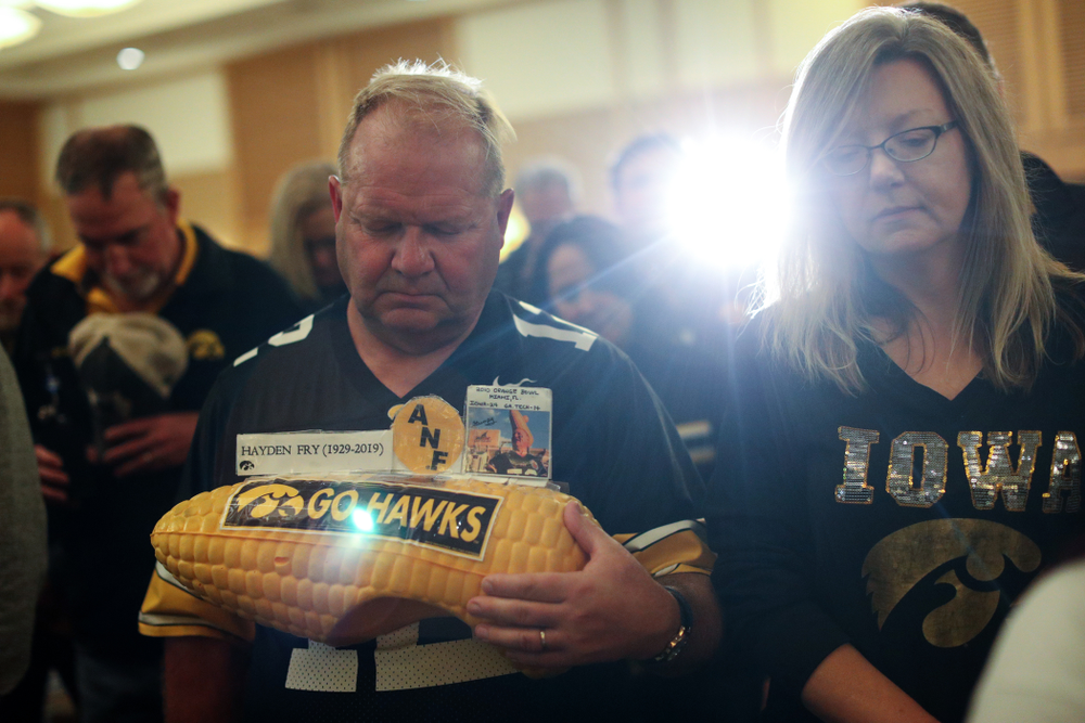 Fans pause for a moment of silence honorary Hayden Fry and Bump Elliott during the Holiday Bowl Hawkeye Huddle Thursday, December 26, 2019 at the Hilton in downtown San Diego. (Brian Ray/hawkeyesports.com)