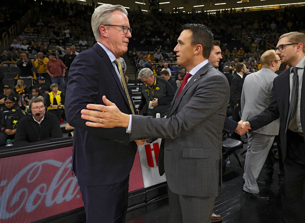 Iowa Hawkeyes head coach Fran McCaffery (from left) shakes hands with SIU Edwardsville Cougars head coach Brian Barone before their game at Carver-Hawkeye Arena in Iowa City on Friday, Nov 8, 2019. (Stephen Mally/hawkeyesports.com)