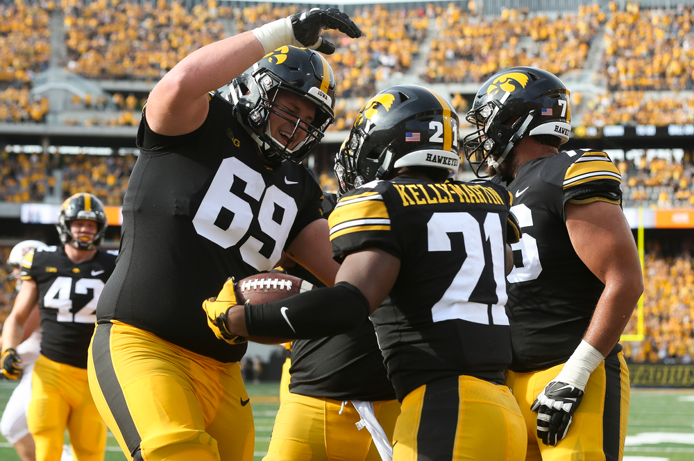 Iowa Hawkeyes offensive lineman Keegan Render (69), Iowa Hawkeyes running back Ivory Kelly-Martin (21)
