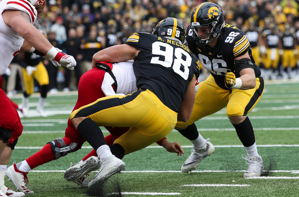 Iowa Hawkeyes defensive end Anthony Nelson (98) and Iowa Hawkeyes defensive lineman Matt Nelson (96) sack the quarterback during a game against Nebraska at Kinnick Stadium on November 23, 2018. (Tork Mason/hawkeyesports.com)