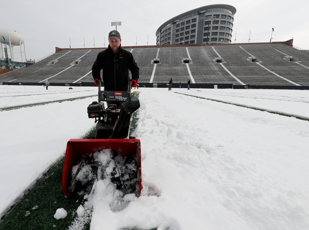 Members of the Iowa Athletics Turf Management staff create the #SnowWave for kids in the Stead Family Children's Hospital Thursday, February