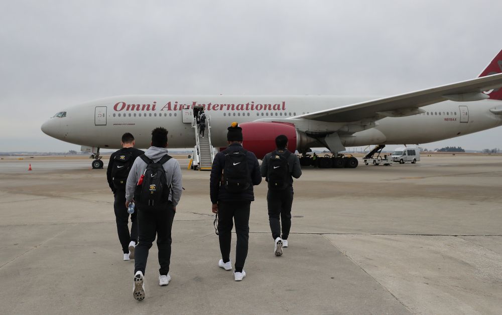 The Iowa Hawkeyes board the team plane Wednesday, December 26, 2018 as they travel to Tampa, Florida for the Outback Bowl. (Brian Ray/hawkeyesports.com)