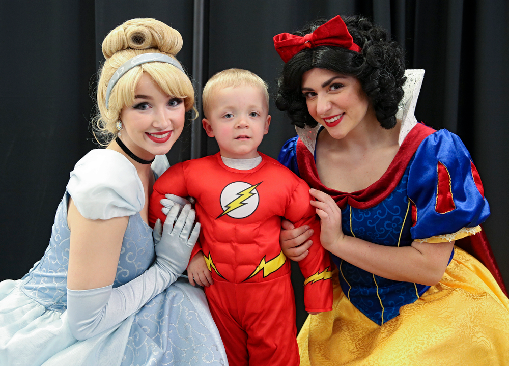 A young fan poses for a picture with two princesses on Superhero and Princess Day before the meet at Carver-Hawkeye Arena in Iowa City on Sunday, March 8, 2020. (Stephen Mally/hawkeyesports.com)