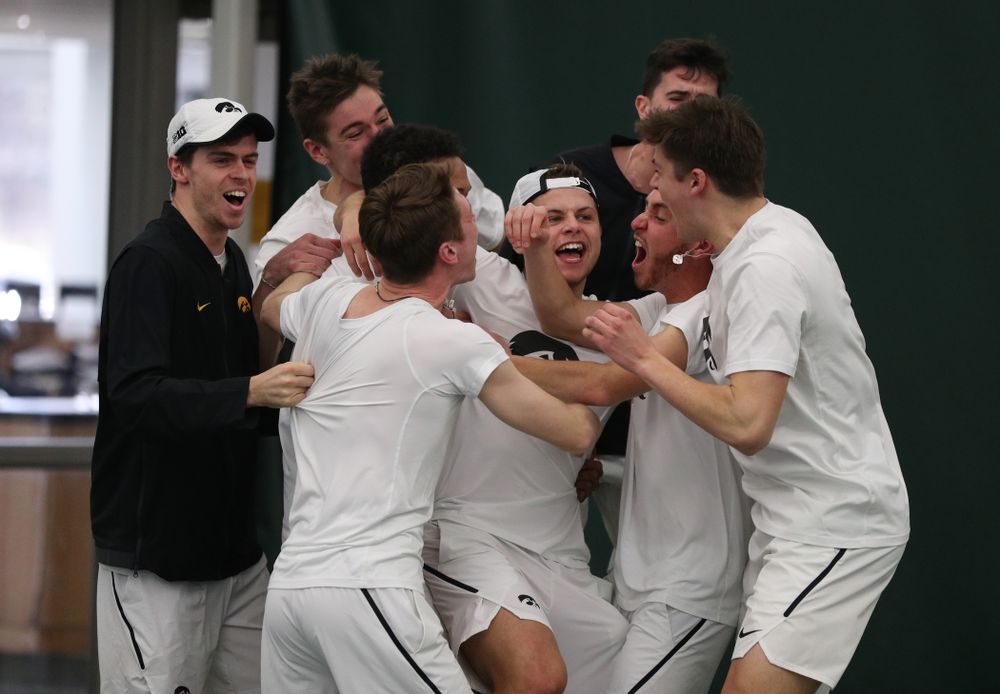 Iowa’s Will Davies celebrates with his teammates after defeating Cornell’s Lev Kazakov in three sets to clench at 4-3 victory Sunday, March 8, 2020 at the Hawkeye Tennis and Recreation Center. (Brian Ray/hawkeyesports.com)