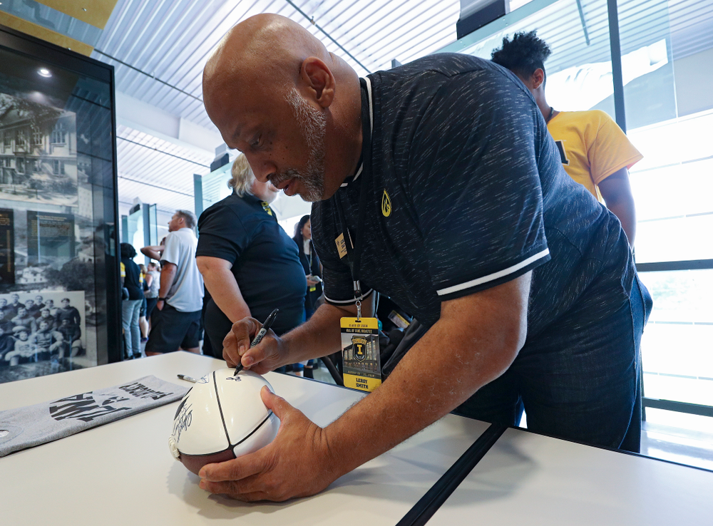 2019 University of Iowa Athletics Hall of Fame inductee Leroy Smith signs a football at the University of Iowa Athletics Hall of Fame in Iowa City on Friday, Aug 30, 2019. (Stephen Mally/hawkeyesports.com)