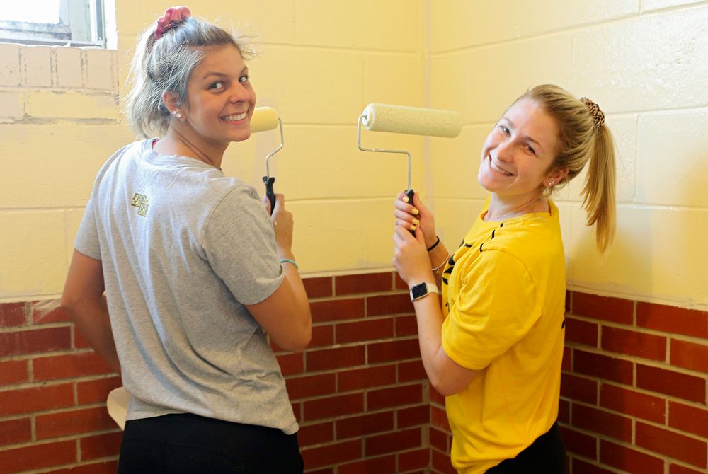 Iowa women's swimming and diving teammates paint a room at the Coralville Community Food Pantry during the 21st annual ISAAC Hawkeye Day of Caring in Coralville on Sunday, Apr. 28, 2019. (Stephen Mally/hawkeyesports.com)