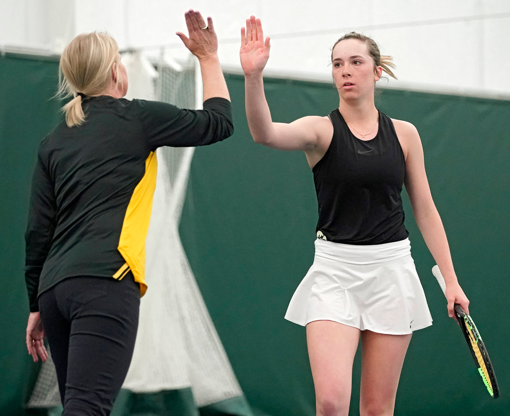 Iowa head coach Sasha Schmid gives a high-five to Samantha Mannix during a match against Indiana at the Hawkeye Tennis and Recreation Complex in Iowa City on Sunday, Mar. 31, 2019. (Stephen Mally/hawkeyesports.com)