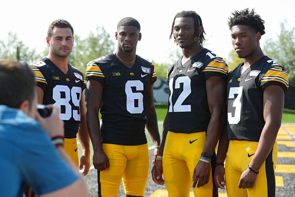 Iowa Hawkeyes wide receiver Nico Ragaini (89), wide receiver Ihmir Smith-Marsette (6), wide receiver Brandon Smith (12), and wide receiver Tyrone Tracy Jr. (3) pose for a picture during Iowa Football Media Day at the Hansen Football Performance Center in Iowa City on Friday, Aug 9, 2019. (Stephen Mally/hawkeyesports.com)