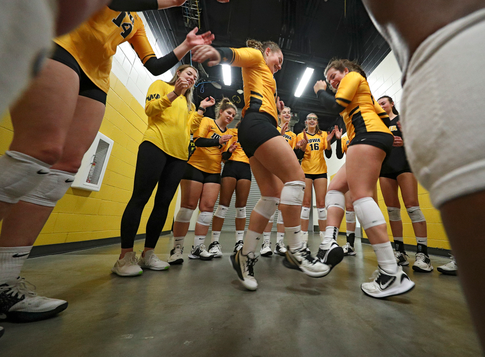 Iowa’s Joslyn Boyer (1) and Emma Lowes (6) dance as the huddle before their match at Carver-Hawkeye Arena in Iowa City on Sunday, Oct 20, 2019. (Stephen Mally/hawkeyesports.com)